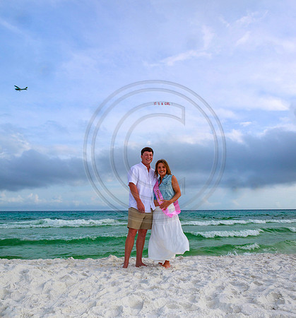 It's a girl baby reveal with a plane on the beach