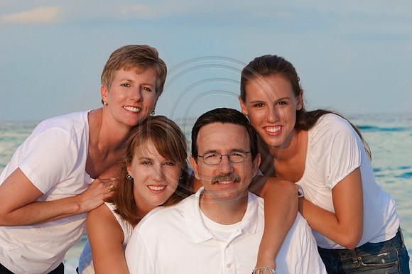 family poses on the beach